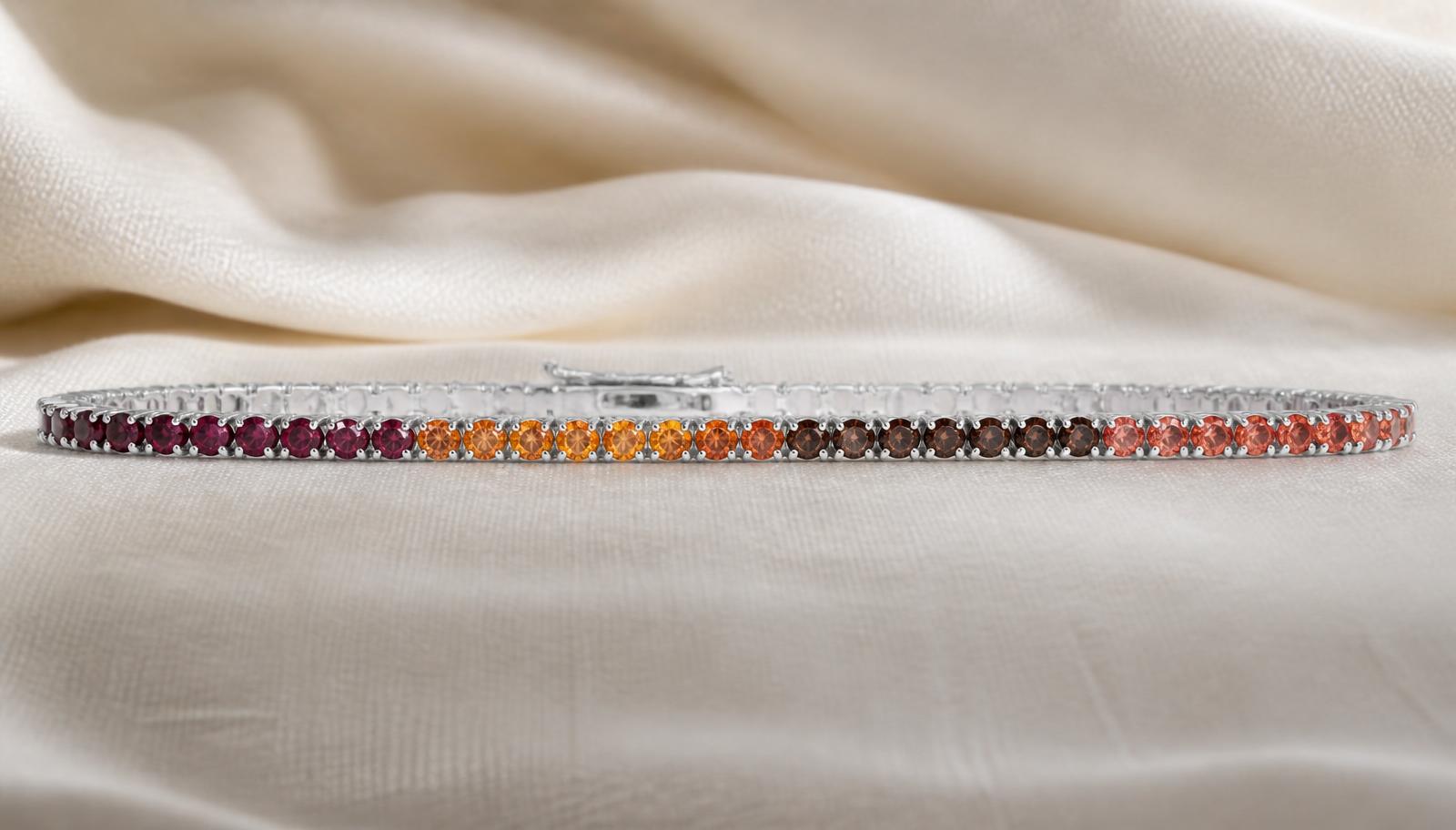 Fine tennis bracelet in maroon, orange and umber stone fields